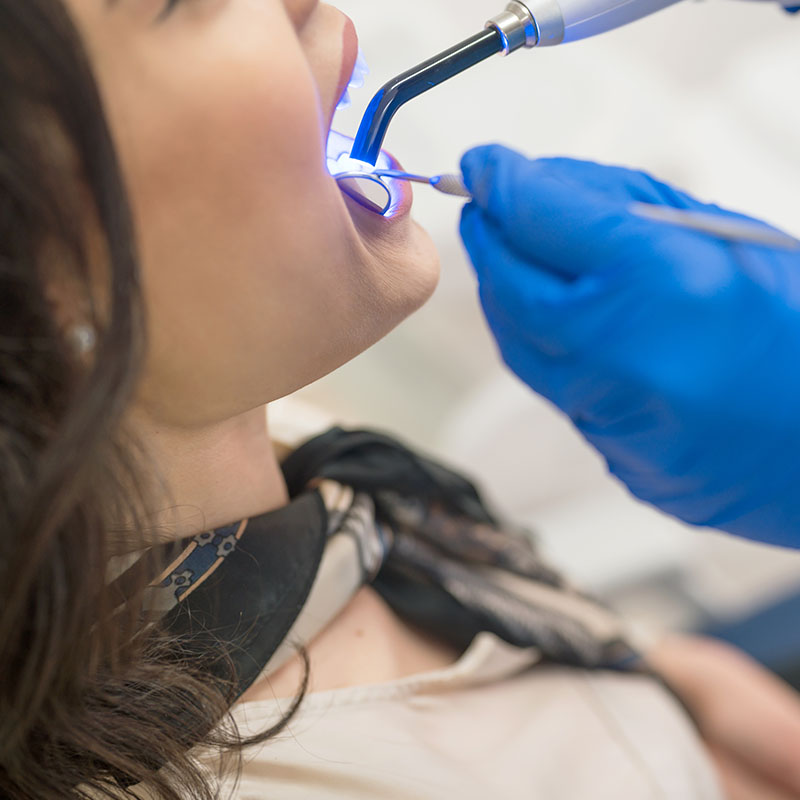 Woman at dentist's office replacing fillings