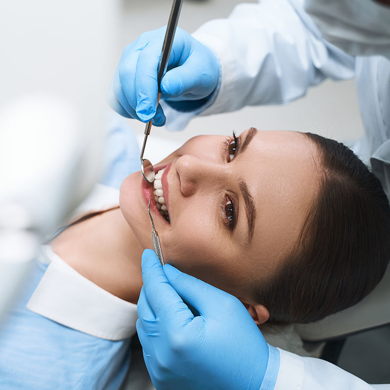 Girl being examined by dentist