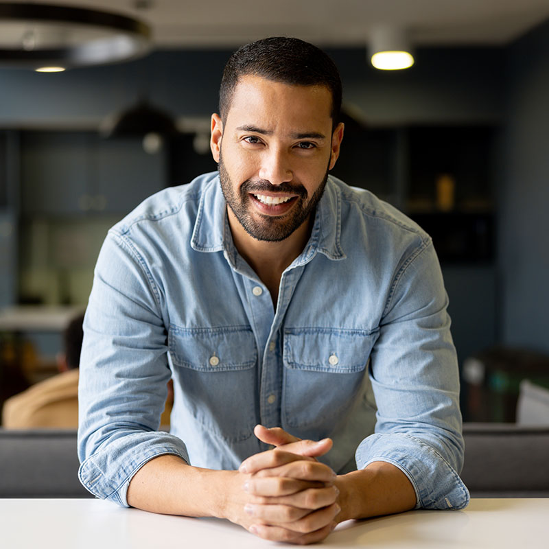 Confident businessman working at the office and smiling