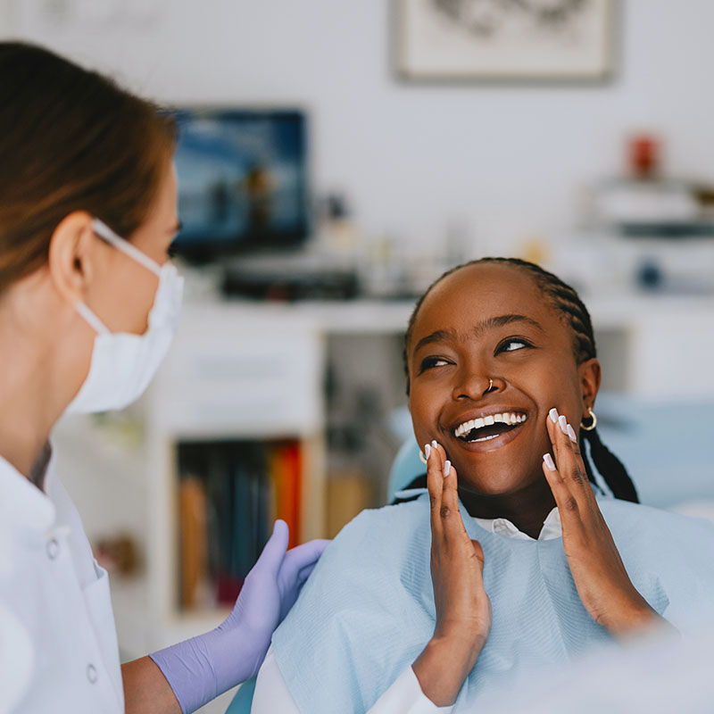 Happy patient expressing joy after a successful dental checkup